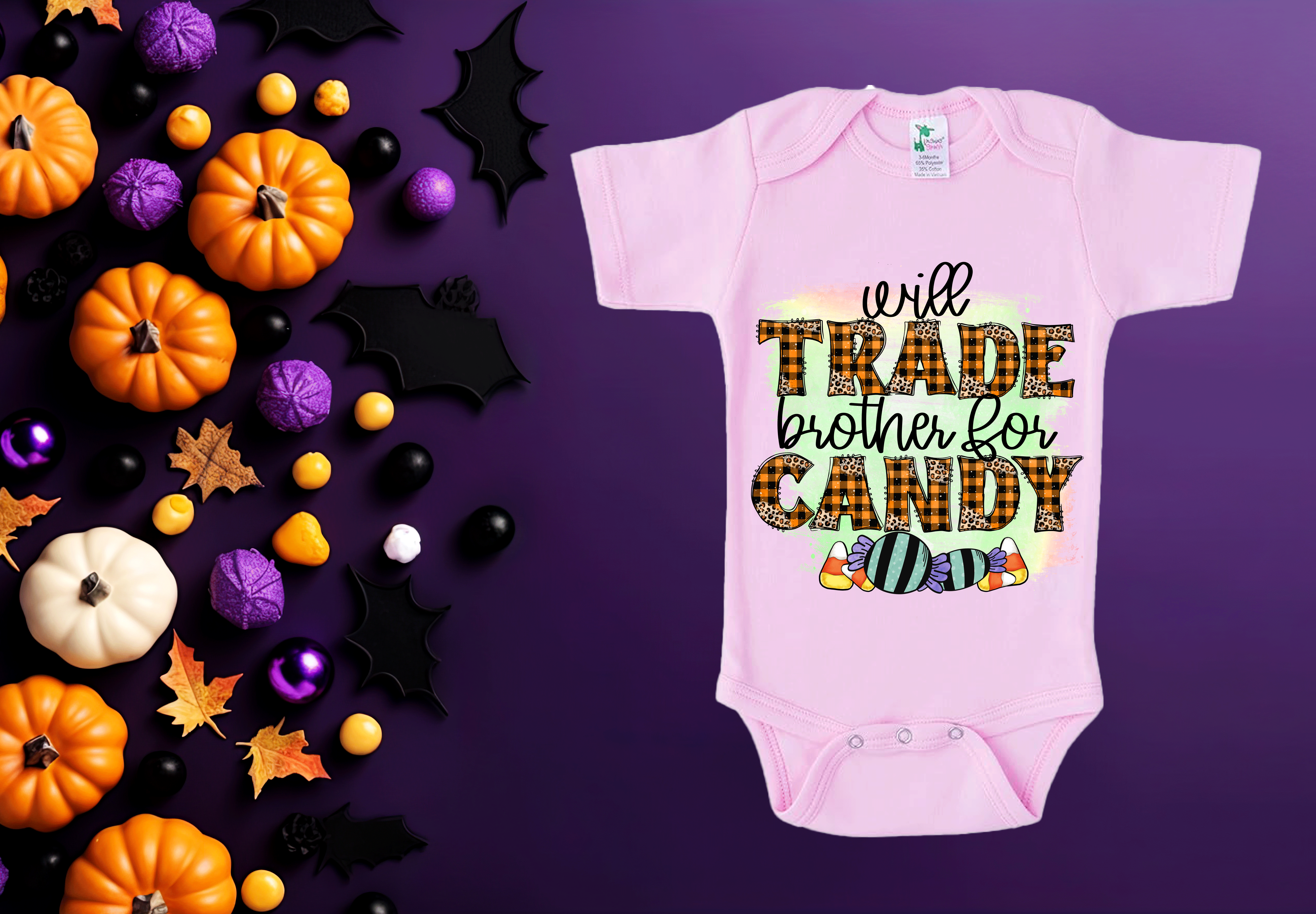 Pink baby onesie with Halloween-themed text on a purple background with candy and pumpkins.