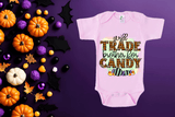 Pink baby onesie with Halloween-themed text on a purple background with candy and pumpkins.