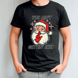 Black t-shirt with a graphic of Santa Claus and text, worn by a person.