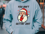 Light blue hoodie with a graphic of Santa Claus and text, worn by a person.
