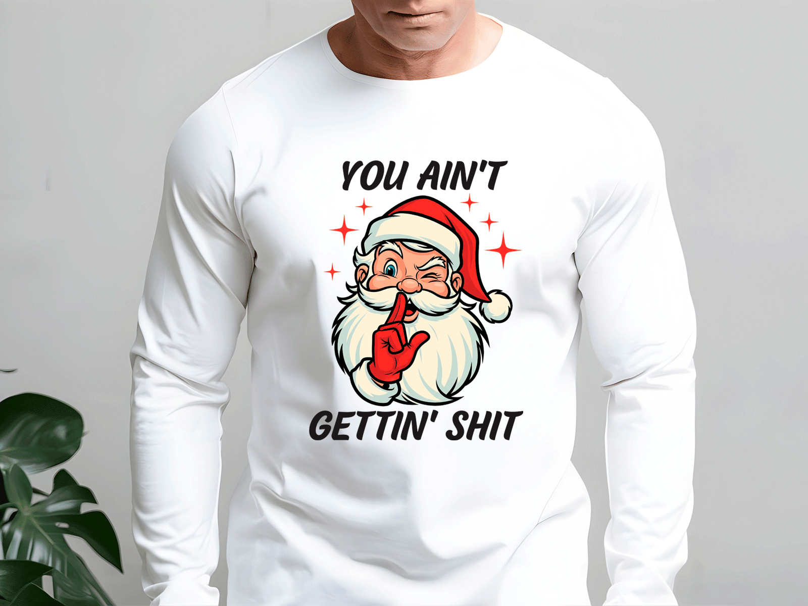White long-sleeve shirt with a graphic of Santa Claus and text on a plain background