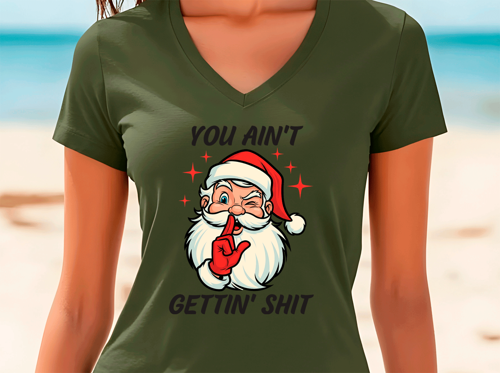 Green t-shirt with a graphic of Santa Claus and text on a beach background