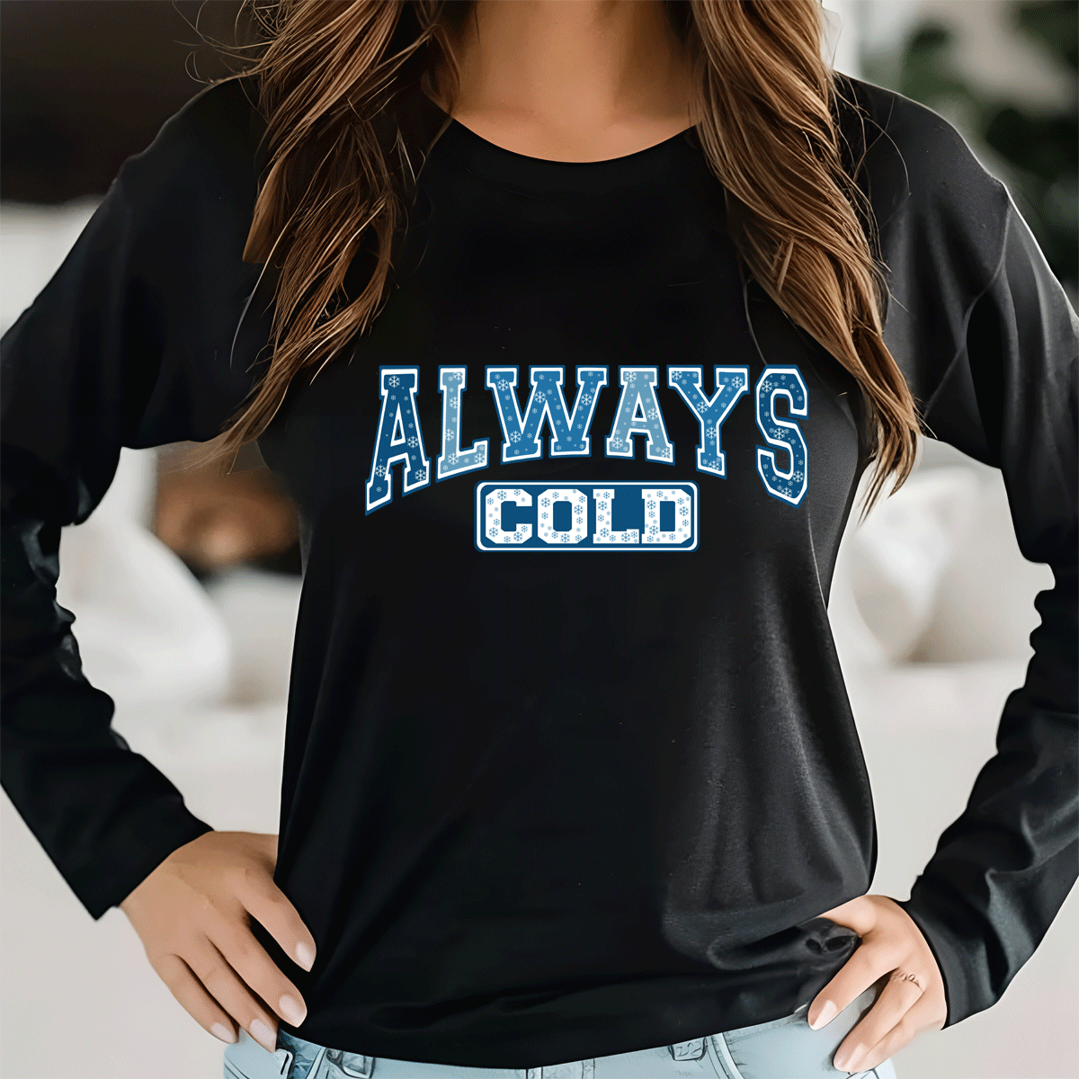 Person wearing a black sweatshirt with 'ALWAYS COLD' text in blue and white.