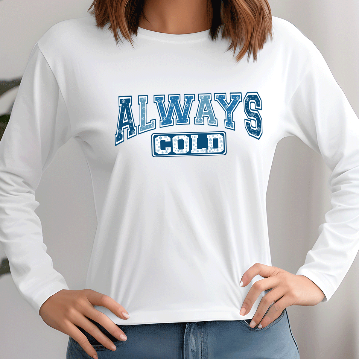 White long-sleeve shirt with 'ALWAYS COLD' text in blue and black worn by a person.