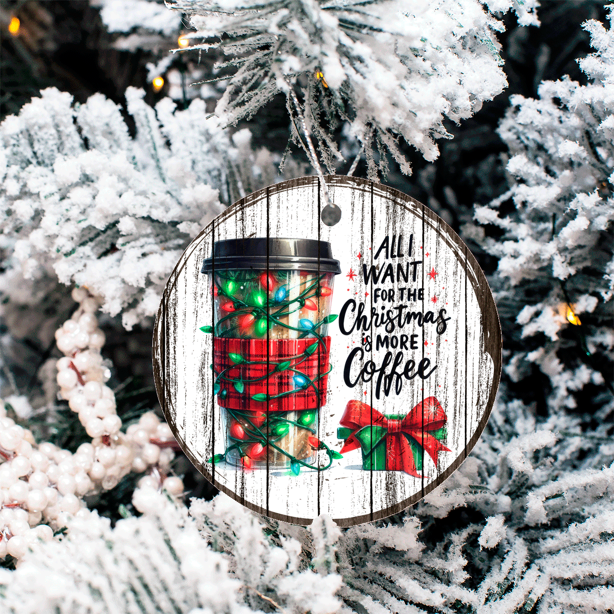 Christmas ornament with coffee cup design and text 'All I want for Christmas is more coffee' on a tree.