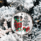 Christmas ornament with coffee cup design and text 'All I want for Christmas is more coffee' on a tree.