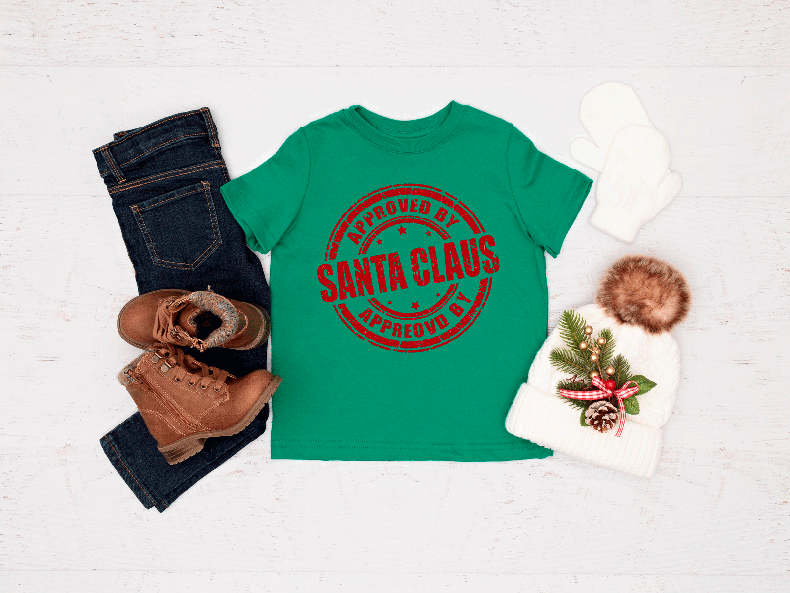 Green t-shirt with 'Approved by Santa Claus' text, jeans, boots, and a hat on a light background