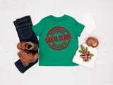 Green t-shirt with 'Approved by Santa Claus' text, jeans, boots, and a hat on a light background