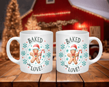 Two white mugs with a gingerbread man design and 'Baked with Love' text on a wooden surface.