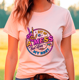 Person wearing a pink t-shirt with colorful graphic design outdoors