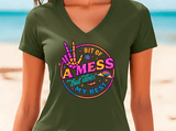 Person wearing a green t-shirt with colorful graphic design on a beach