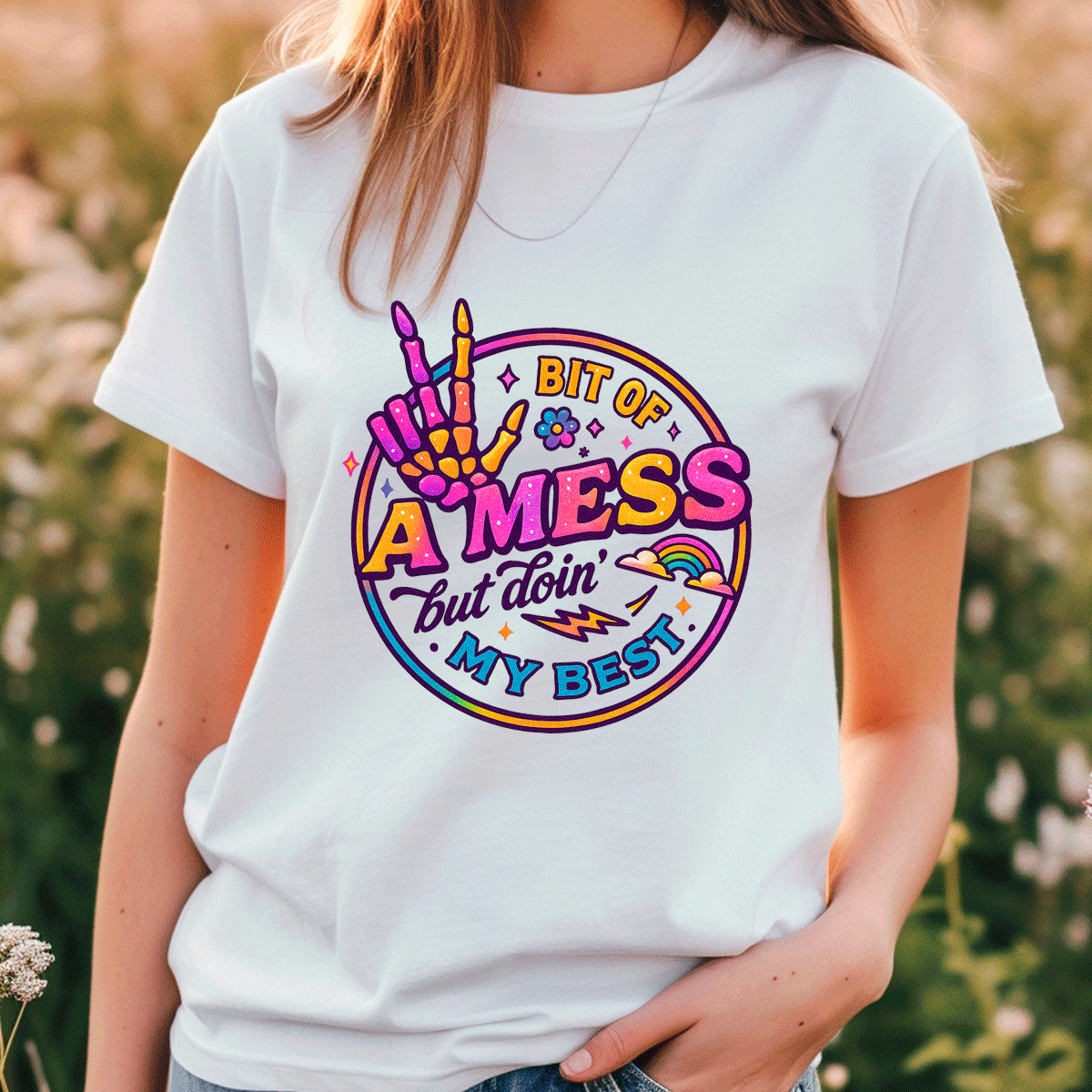 Person wearing a white t-shirt with colorful graphic design outdoors