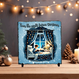 Decorative plaque with a Christmas scene of a child reading by a window, surrounded by festive decorations.