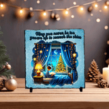 Decorative plaque with a child by a window, Christmas tree, and festive lights on a stand.