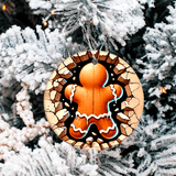 Decorative gingerbread man ornament on a snowy tree branch