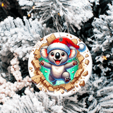 Christmas ornament with a koala wearing a Santa hat on a snowy tree background