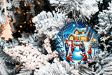 Decorative Christmas ornament with a snowy village scene on a tree.
