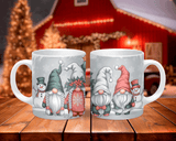 Two mugs with festive gnome and snowman designs on a wooden surface.