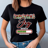 Person wearing a black t-shirt with 'Christmas Joy Loading' text design.
