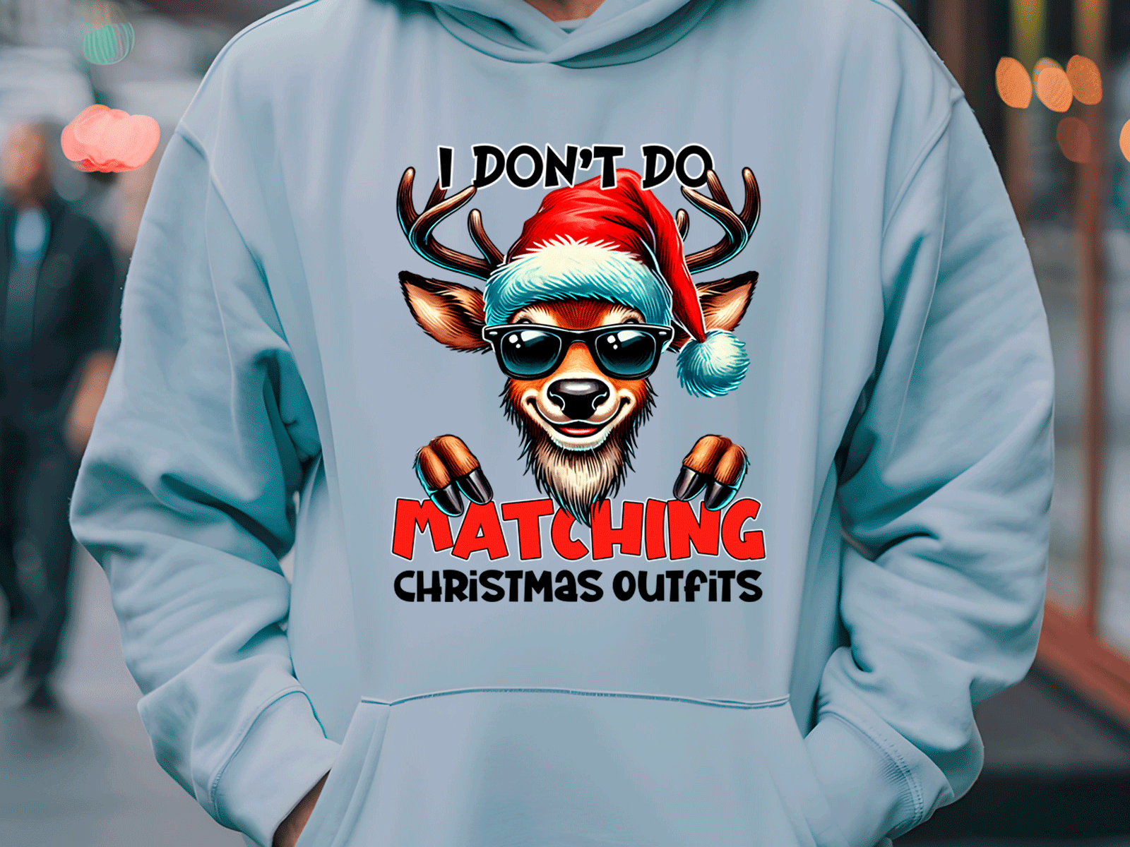 Light blue hoodie with a reindeer graphic and text in an urban setting