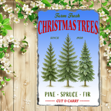 Vintage-style sign advertising 'Farm Fresh Christmas Trees' with trees and flowers on a wooden background.