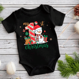 Black baby onesie with Christmas-themed design featuring a snowman and text on a wooden surface.