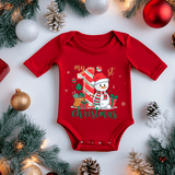 Red baby onesie with Christmas design surrounded by festive decorations on a white background