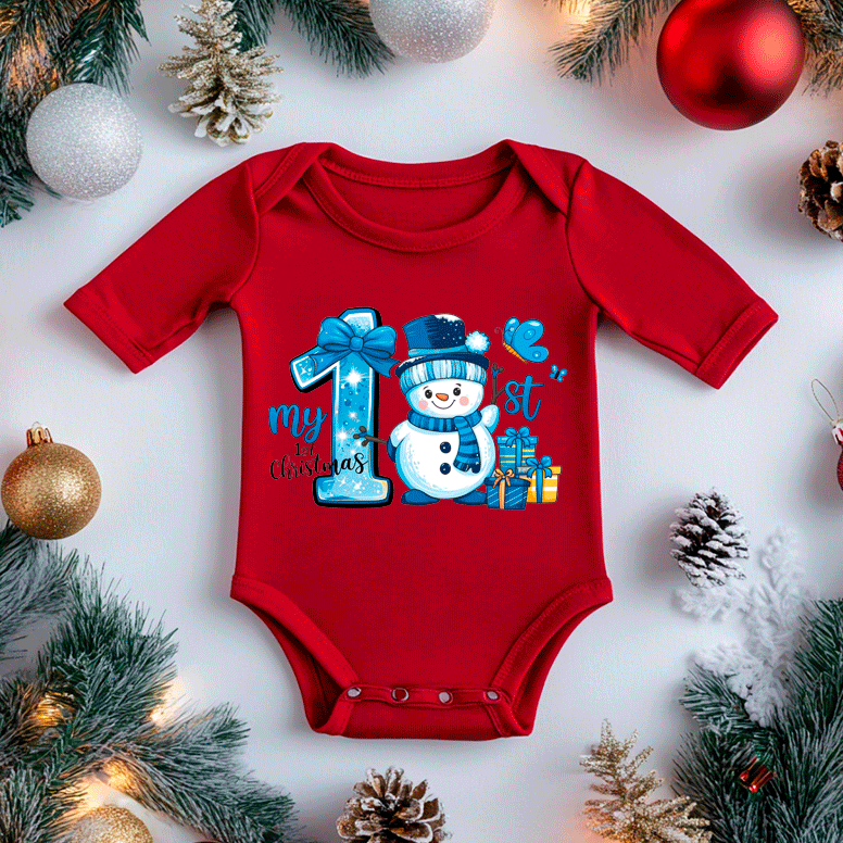 Red baby onesie with snowman design and Christmas decorations on a white background