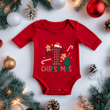 Red baby onesie with 'My 1st Christmas' text surrounded by holiday decorations on a white background