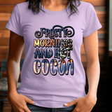 Person wearing a purple t-shirt with 'Frosty mornings and hot cocoa' text.