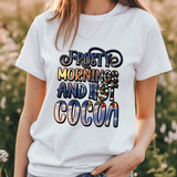 Person wearing a white t-shirt with 'Frosty mornings and hot cocoa' text in a scenic font.