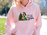 Person wearing a pink hoodie with a Christmas-themed design and text.
