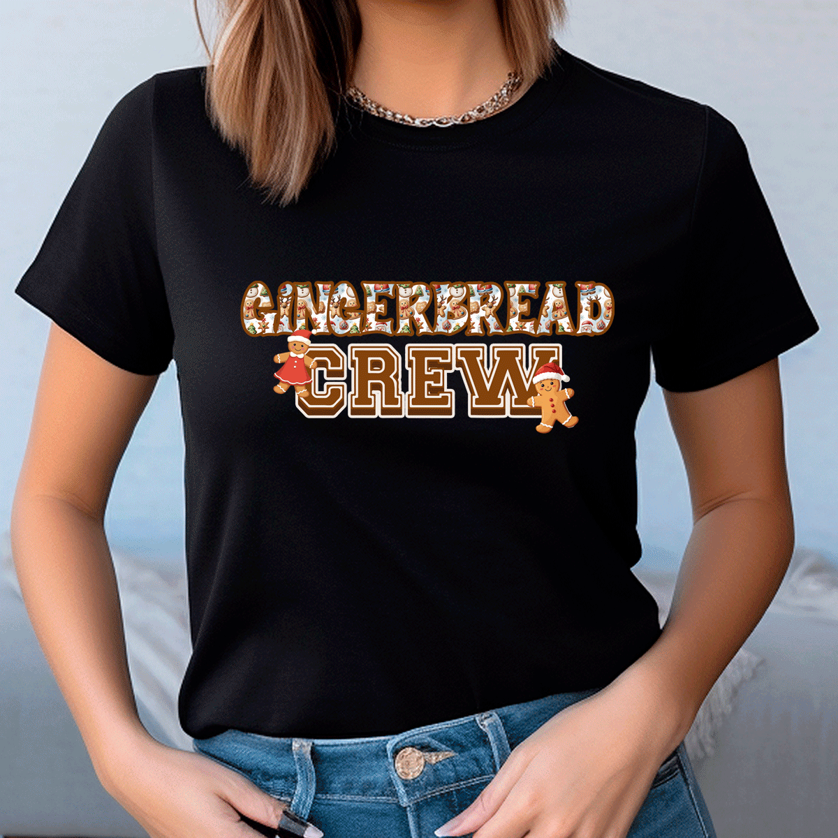 Person wearing a black t-shirt with 'GINGERBREAD CREW' text and gingerbread men graphics.