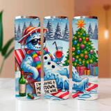 Three tumblers with a snowman design and Christmas tree, placed on a surface.