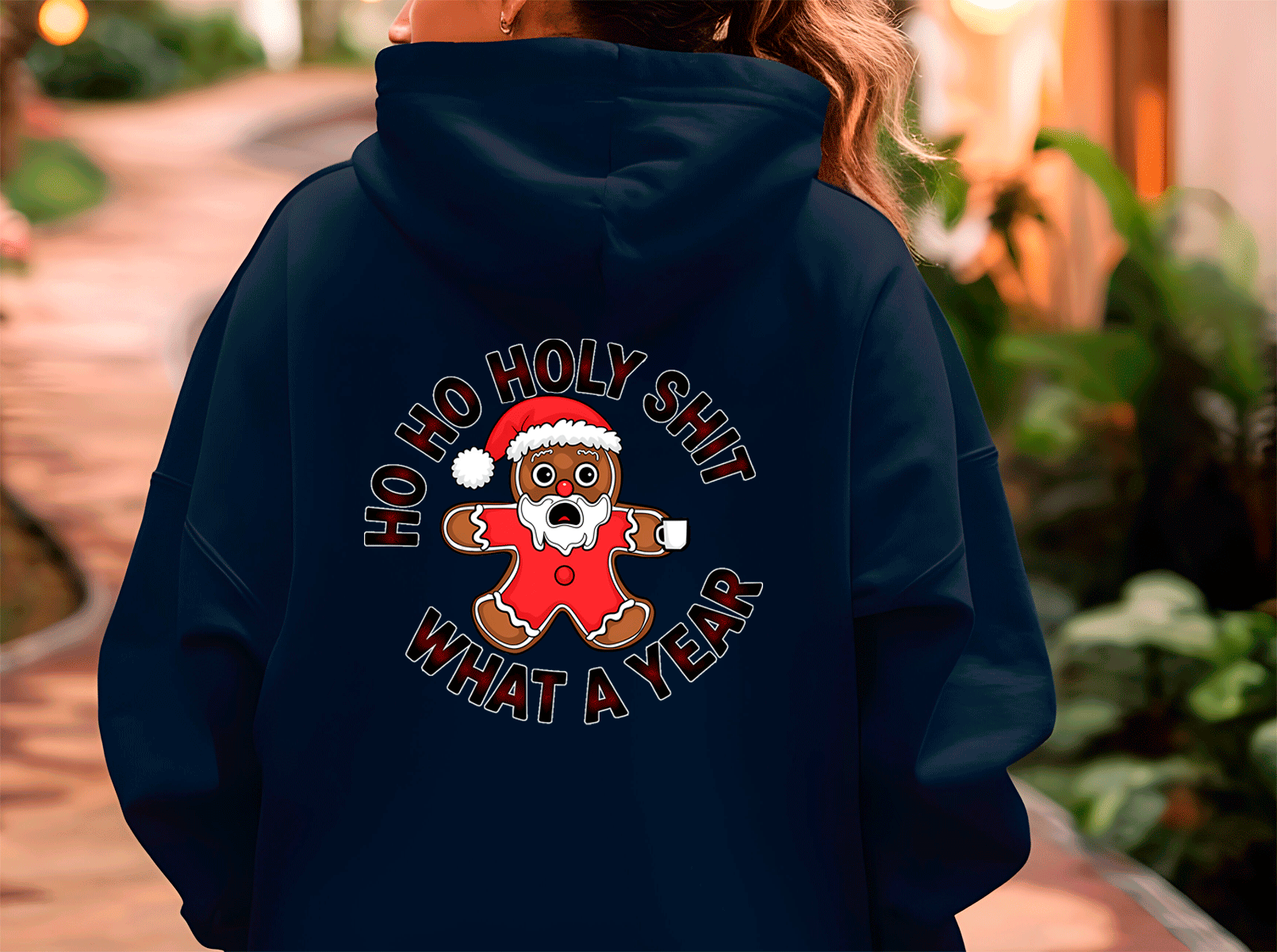 Navy blue hoodie with a graphic design on the back featuring a gingerbread man and text.