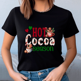 Black t-shirt with 'Hot Cocoa Season' graphic design worn by a person.