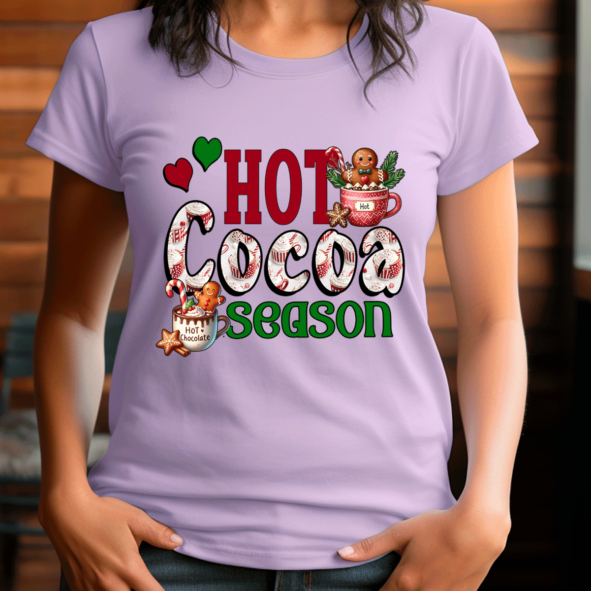 Person wearing a purple t-shirt with 'Hot Cocoa Season' text and graphics.