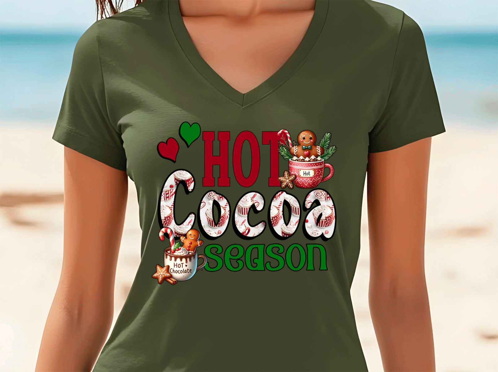Green t-shirt with 'Hot Cocoa Season' design on a beach background