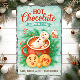 Decorative sign with a snowman in hot chocolate, surrounded by Christmas decorations.