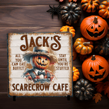Halloween-themed sign with pumpkins and a scarecrow on a slate background