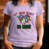 Person wearing a purple t-shirt with a heart-shaped design and text 'Let your heart be light'.