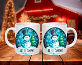 Two mugs with a snowman design and 'Let It Snow!' text on a wooden table with a festive background.