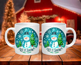 Two white mugs with a snowman design and 'Let it Snow!' text on a wooden surface.