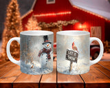 Two Christmas-themed mugs on a wooden table with a festive background.