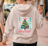 Person wearing a hoodie with a Christmas tree design and 'Merry & Bright' text.