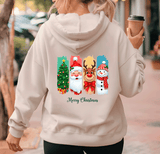 Person wearing a light gray hoodie with Christmas-themed design on the back, holding a coffee cup.