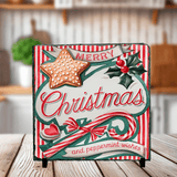 Decorative Christmas photo  slate with candy cane, star, and holly on a wooden surface.