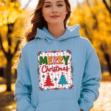 Person wearing a light blue hoodie with a 'Merry Christmas' design outdoors.