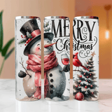 Three Christmas-themed tumblers with snowman, cardinal, and tree designs on a white surface.