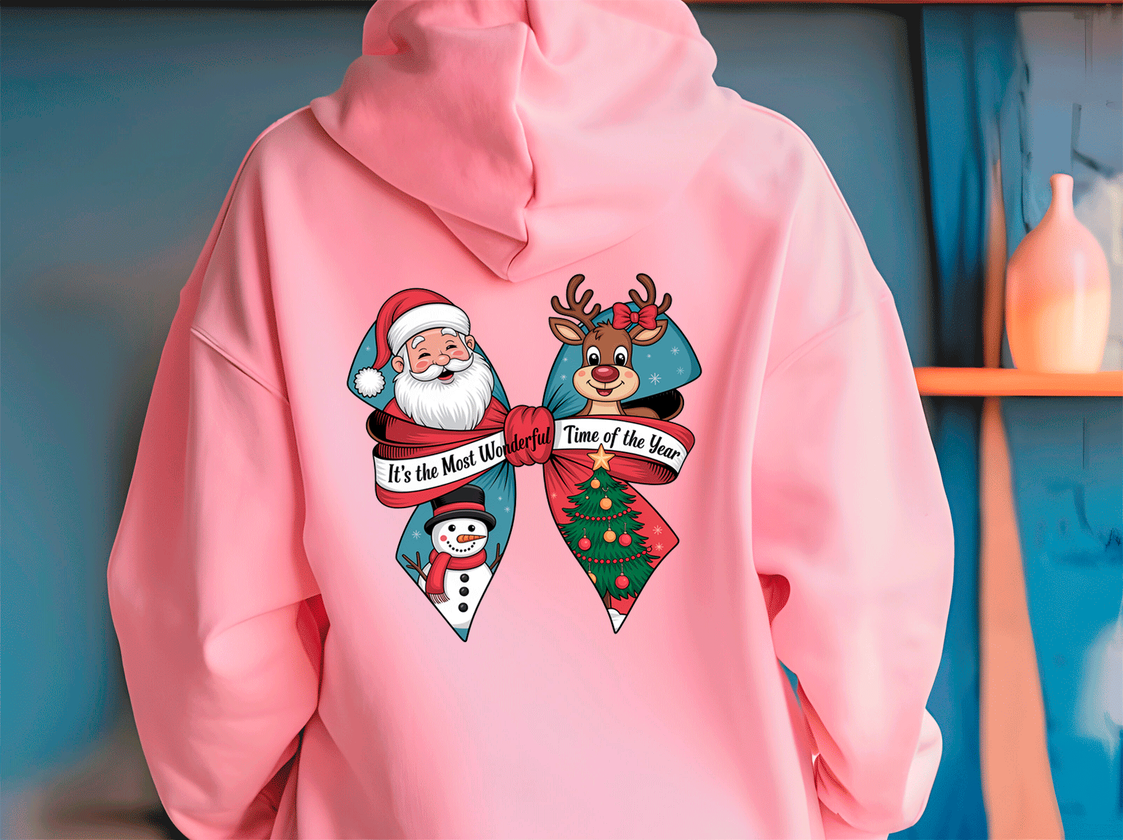 Pink hoodie with Christmas-themed design featuring Santa Claus, a reindeer, and snowman on a blue background.